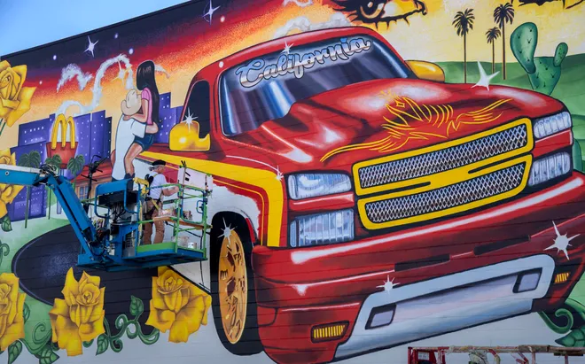 Truck parked in front of the mural.